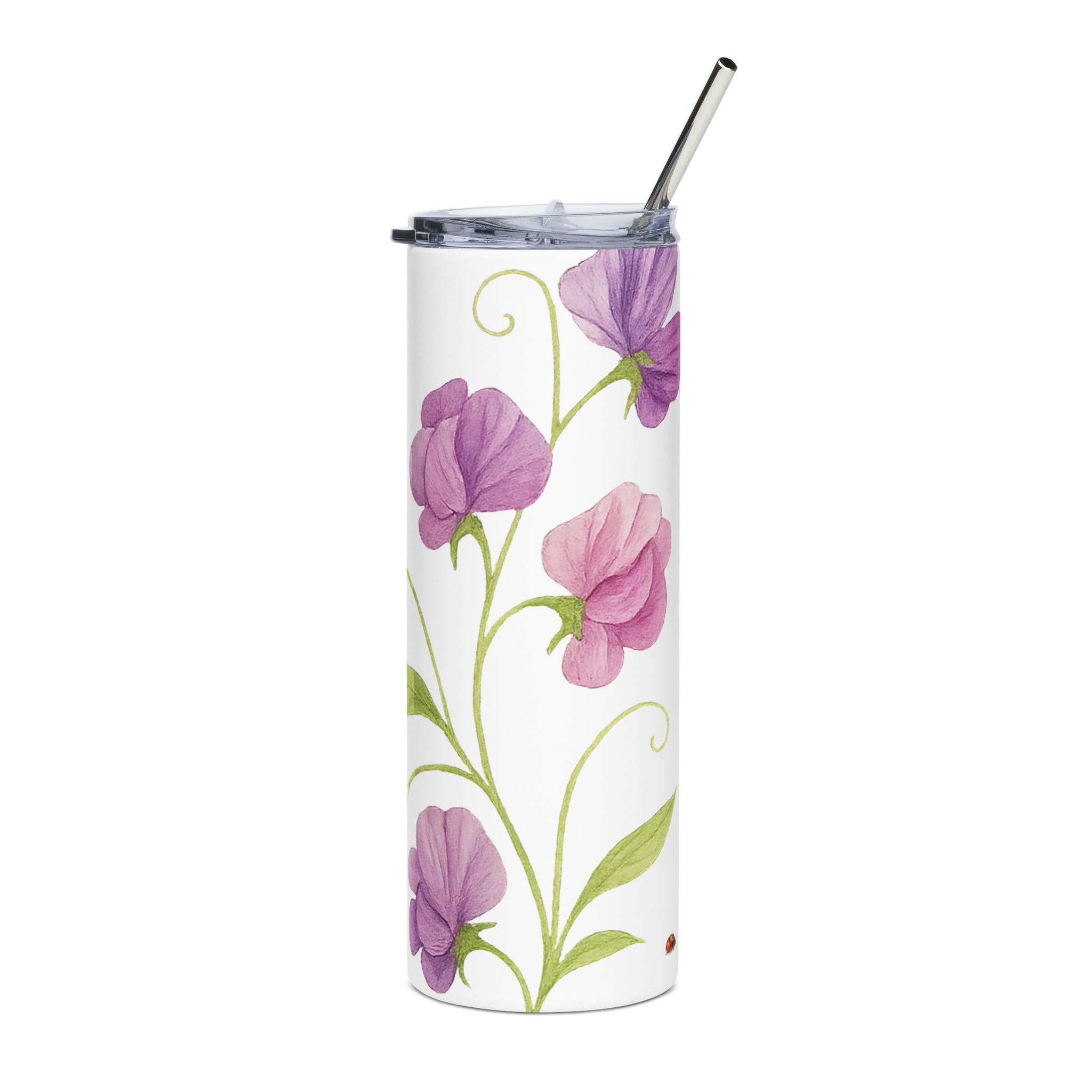 Tumbler with floral design and metal straw on a white background